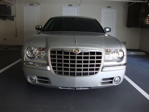 2008 Chrysler 300 - Silver Chrysler 300 sedan with tinted windows and a chrome grille is parked in a garage.