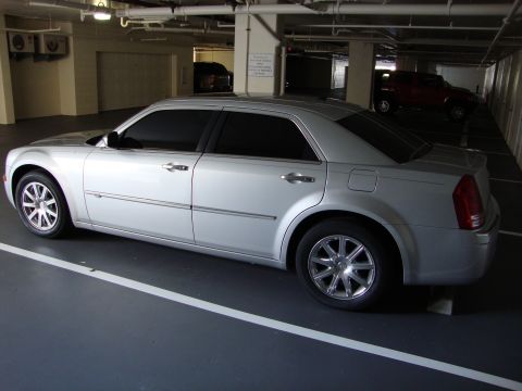 2008 Chrysler 300 - A silver Chrysler 300 sedan is parked in a dimly lit indoor parking garage.