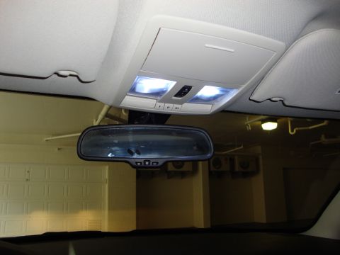2008 Chrysler 300 - Interior view of a vehicle's overhead console and rearview mirror, with a garage door reflected.