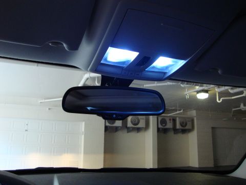 2008 Chrysler 300 - The interior of a vehicle shows the overhead console with illuminated blue LED lights and a rearview mirror.