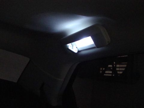 2008 Chrysler 300 - The interior of a vehicle shows a bright LED dome light illuminating the dark cabin.