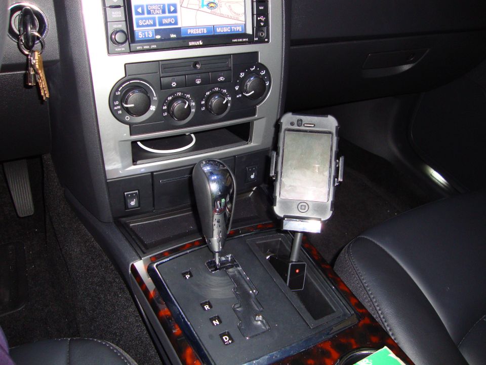2008 Chrysler 300 interior showing center console with gear shifter, climate controls, infotainment screen, and an iPhone mounted on a stand