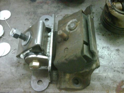 1996 Ford Bronco - A close-up view of a vehicle motor mount, showing its construction with rubber and metal parts.