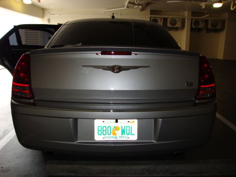 2008 Chrysler 300 - The rear of a Chrysler 300 sedan is shown, its distinctive taillights and emblem.