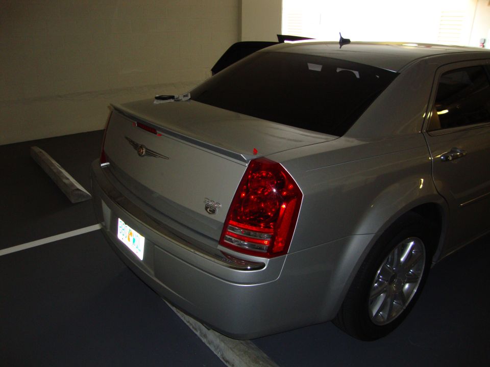Silver Chrysler 300 sedan, rear view. Lip spoiler on trunk