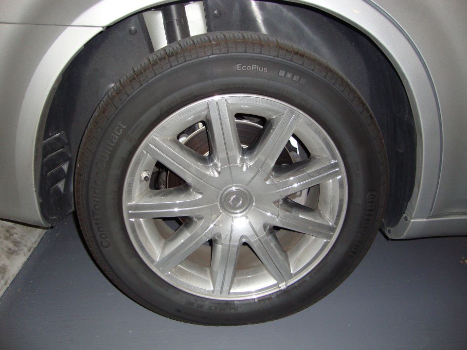 Polished alloy wheel with Continental ContiTouringContact EcoPlus tire on a silver sedan