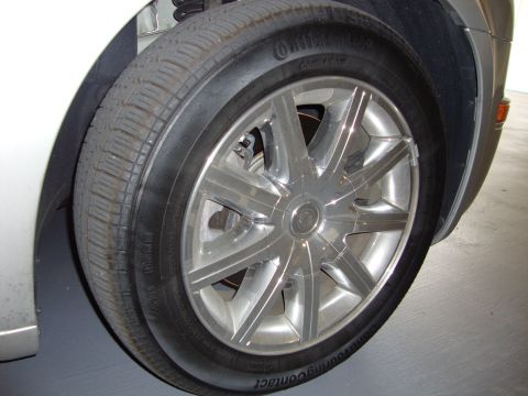 2008 Chrysler 300 - Close-up of a chrome 10-spoke wheel and Continental tire on a vehicle.