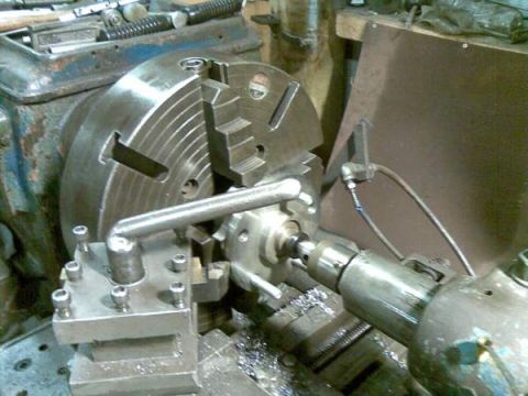 1969 MINI Cooper - Lathe setup with chuck and cutting tool, metal shavings present. Supermotors.net logo visible.