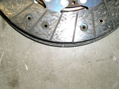 1986 Toyota Hilux - This is a close-up view of a vehicle's clutch disc, showing wear and tear on its friction material.