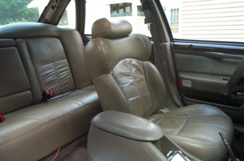 1995 Ford Taurus - Interior view of a vehicle with tan leather seats and a center console.