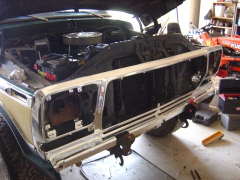 1979 Ford Bronco - The front grille and engine bay of a 1979 Ford Bronco are visible, with the hood open for access.