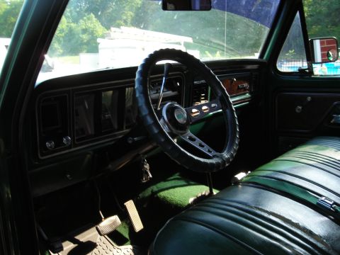 1979 Ford Bronco - Interior view of a 1979 Ford Bronco, showing the dashboard, steering wheel, and front bench seat.