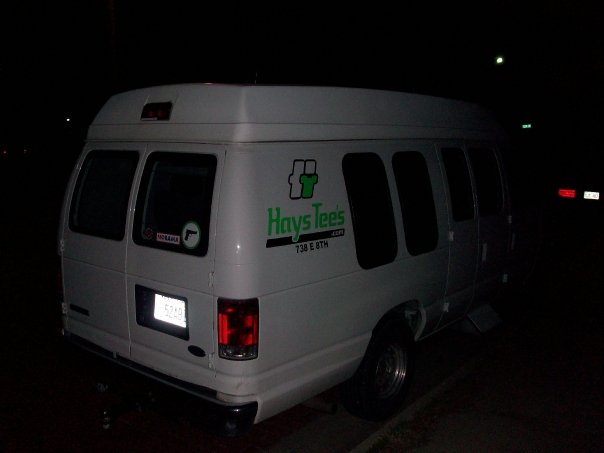 White van with a green HaysTees.com logo on the side and a sticker of a gun