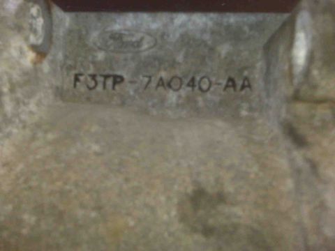 1995 Ford Bronco - Close-up of a metal part showing the Ford logo and part number F3TP-7A040-AA.