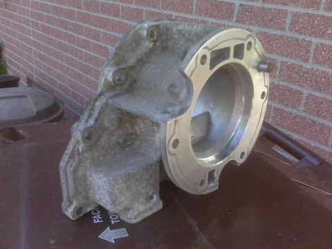 1995 Ford Bronco - This is an automotive part, possibly a transmission housing, shown outdoors.