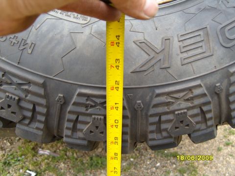 1989 Ford Bronco - A measuring tape is used to show the size of a tire tread, indicating a measurement of about 42 inches.