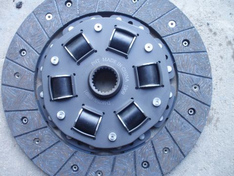 1993 Ford Probe - A close-up view of a vehicle clutch disc, showing its friction material and center spline.