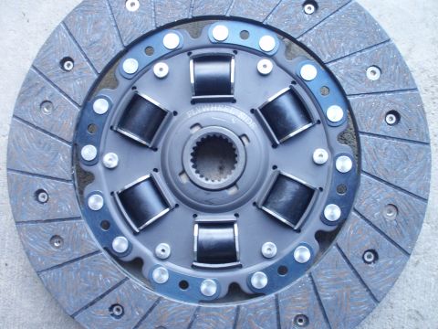 1993 Ford Probe - A clutch disc, identified by "Flywheel Side" text, is shown with its internal springs and friction material.