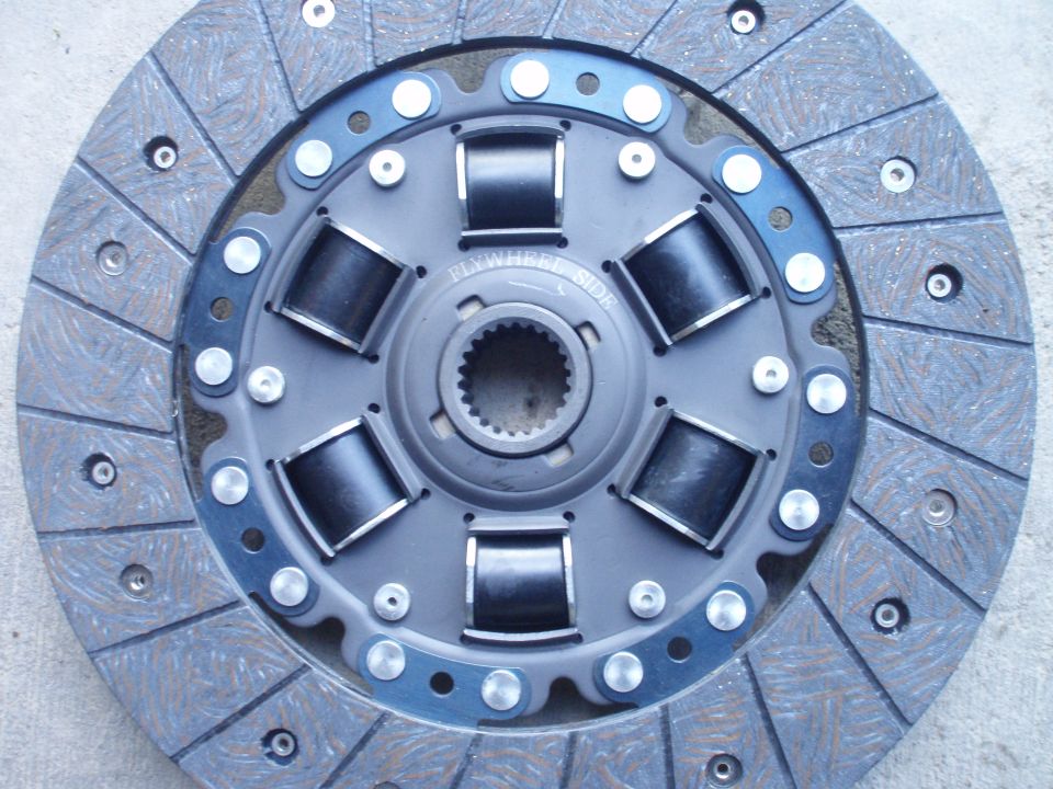 Clutch disc with "Flywheel Side" text, showing springs and friction material