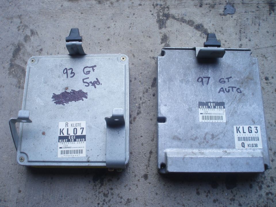 two car ECUs, one labeled '93 GT 5pd' and the other '97 GT AUTO'