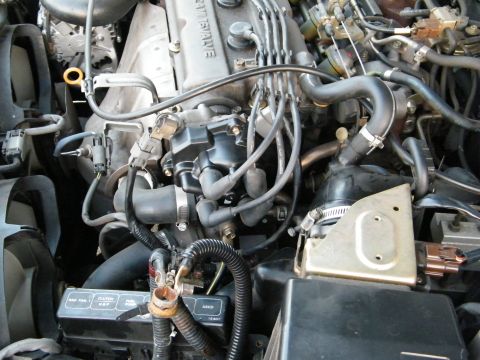 1982 Ford Bronco - Close-up view of a vehicle's engine compartment, showing intricate mechanical details and wiring.