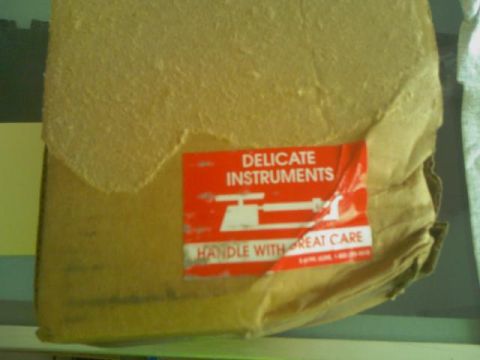 1995 Ford Bronco - A cardboard box is marked with a red label indicating delicate instruments and the need for careful handling.