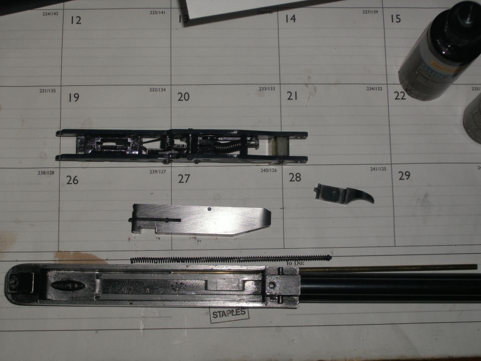 Disassembled door latch components arranged on a calendar
