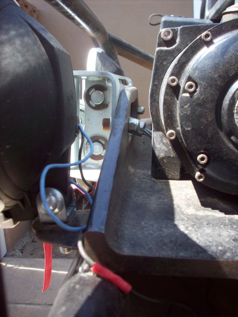 1995 Ford Bronco - Detail shot of electrical wiring and a metal bracket on a vehicle part.