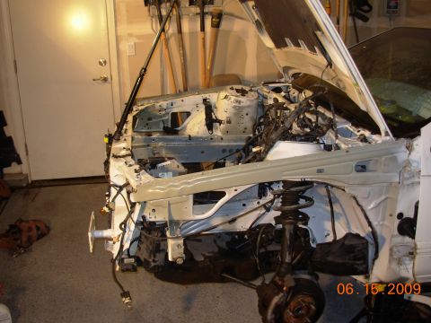 1995 Ford Taurus - The engine bay of a 1995 Ford Taurus is shown disassembled, with the hood open.
