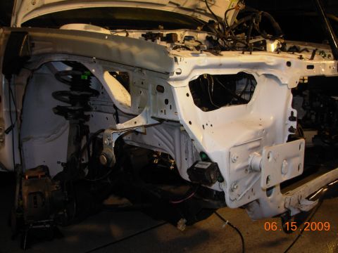1995 Ford Taurus - The front end of a car is shown with the hood open, revealing the engine bay and suspension system.