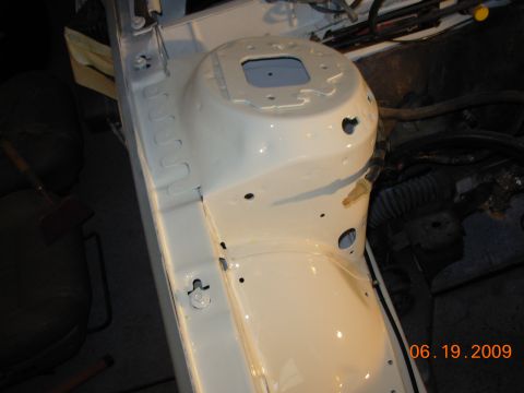 1995 Ford Taurus - Close-up of a clean, white-painted vehicle chassis, likely the engine bay, with visible wiring and hoses.
