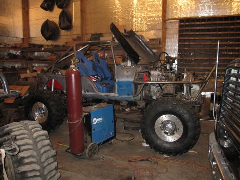 1992 Ford Bronco - Custom off-road vehicle build in progress, a roll cage and racing seats.