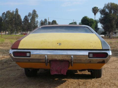 1975 Ford Ranchero - The rear of a 1975 Ford Ranchero shows its distinctive two-tone paint scheme and chrome bumper.