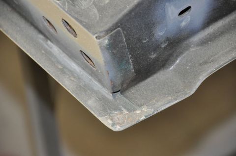 1996 Ford Bronco - Detail of a vehicle's tailgate corner, showing signs of wear and rust.