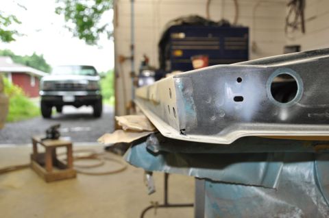 1996 Ford Bronco - A truck is parked in a garage, facing the camera, with a metal part in the foreground.