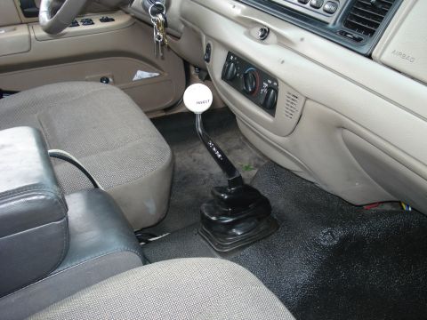 2000 Ford Crown Victoria - Interior of a 2000 Ford Crown Victoria, a Hurst shifter and beige cloth seats.