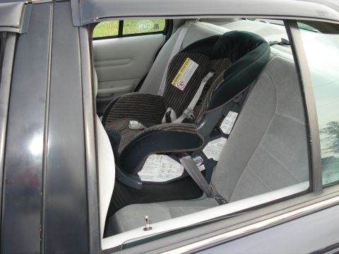 2000 Ford Crown Victoria - Child car seat installed in the rear passenger seat of a 2000 Ford Crown Victoria.