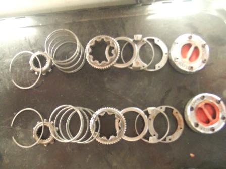 1996 Ford Bronco - Two sets of vehicle hub assembly parts are displayed, including gears, rings, and locking mechanisms.
