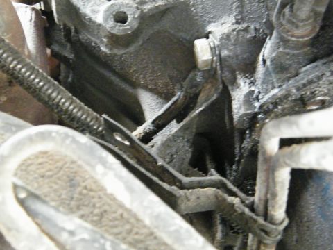 1982 Ford Bronco - A detailed view of engine parts, showing wear and accumulated oil, with a Supermotors.net watermark.