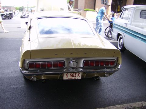 1970 Ford Ranchero - Gold 1969 Shelby GT500 Mustang with a white stripe and a white pickup truck beside it.