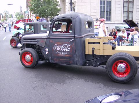 1970 Ford Ranchero - This custom truck features Coca-Cola branding and red wheels, with a flatbed in the rear.