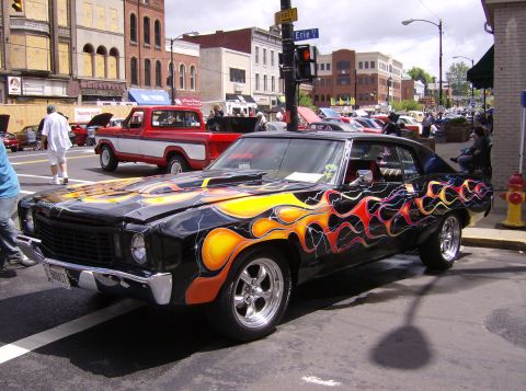 1970 Ford Ranchero - Customized 1970 Ford Ranchero with flame graphics and aftermarket wheels at a car show.