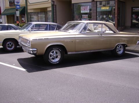 1970 Ford Ranchero - A gold coupe with a white roof and interior is parked on the street.