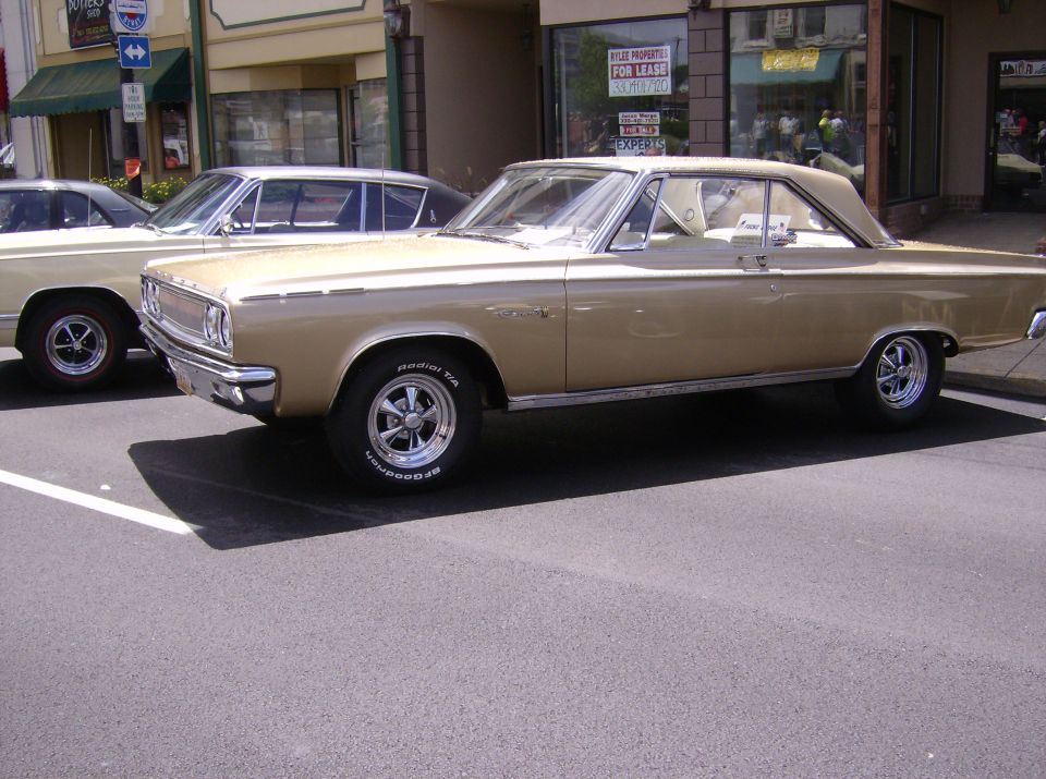 Gold coupe with white roof and interior, side view