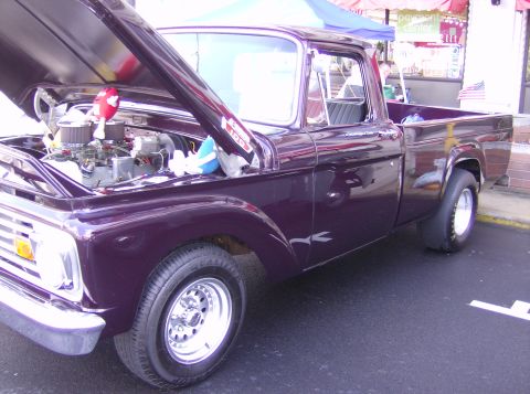 1970 Ford Ranchero - Customized pickup truck with engine exposed, parked outdoors.