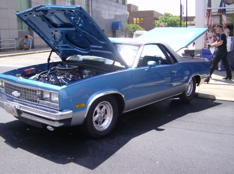 1970 Ford Ranchero - A blue 1970 Ford Ranchero is displayed with its hood and trunk open at an outdoor event.