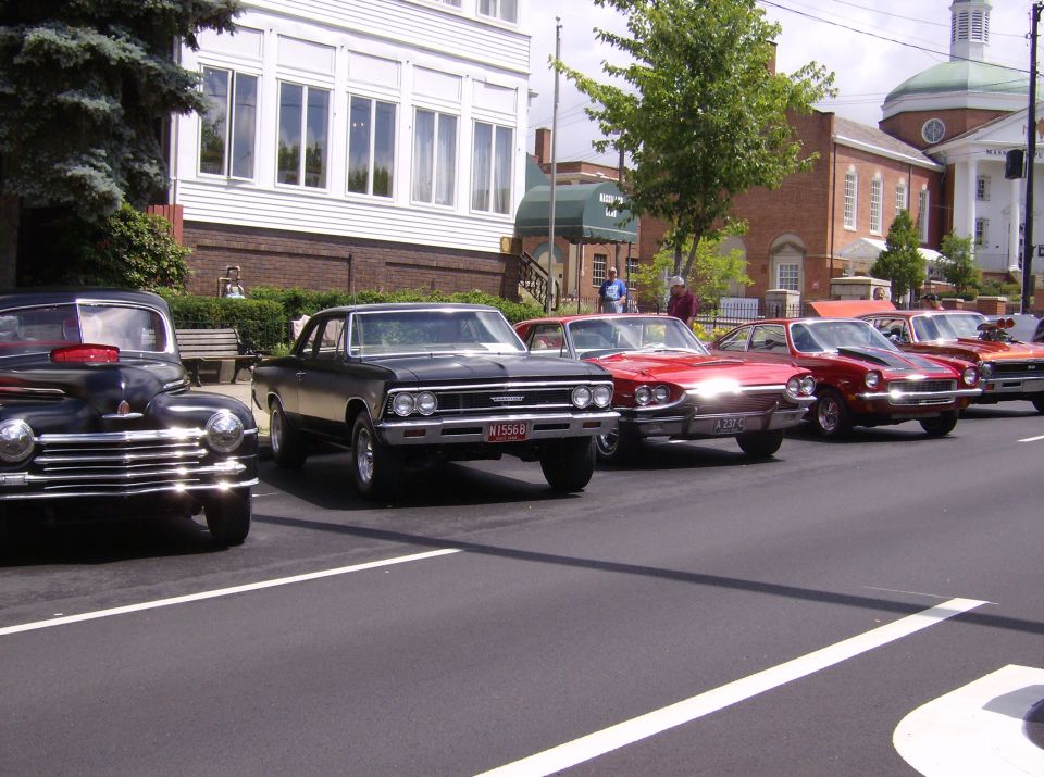 Black 1966 coupe with chrome grille and red license plate