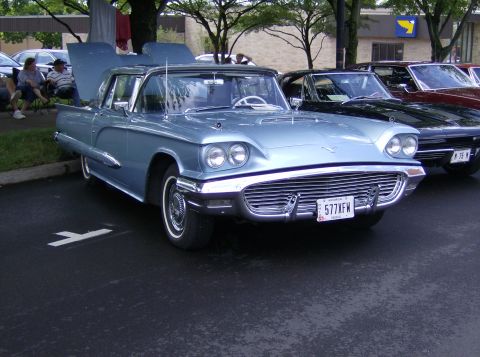 1970 Ford Ranchero - A light blue 1958 Ford Thunderbird convertible is parked with its hood open at a car show.