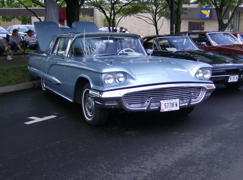 Light blue 1958 Ford Thunderbird convertible front view with hood open