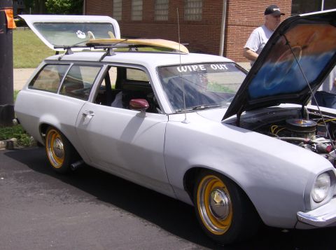 1970 Ford Ranchero - Gray Ford Pinto wagon with surfboards on roof rack and 'WIPE OUT' sticker on windshield.